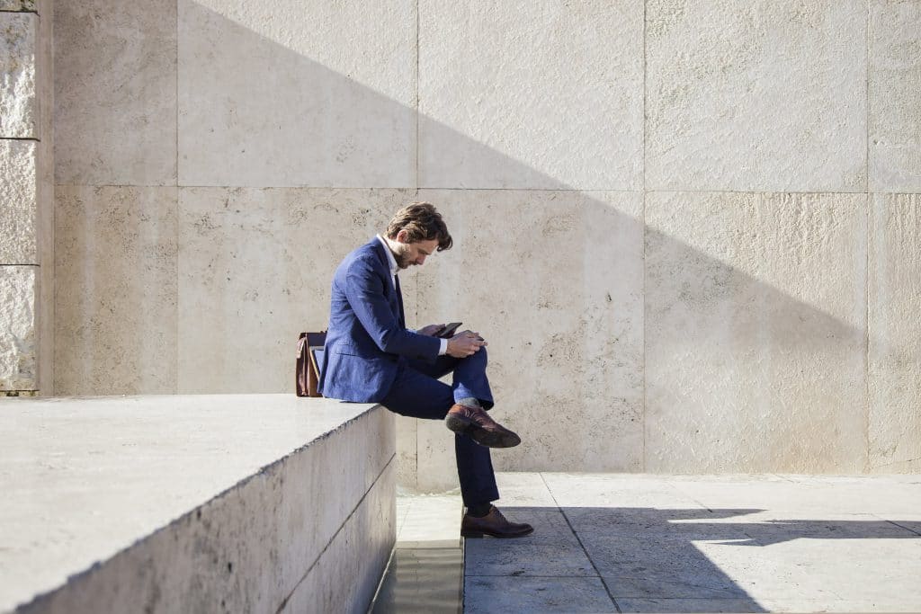 Professional-man-seated-outside-the-office-000056755952_Double-min